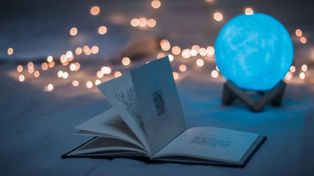 Opened book beside crystal ball by Dollar Gill on Unsplash